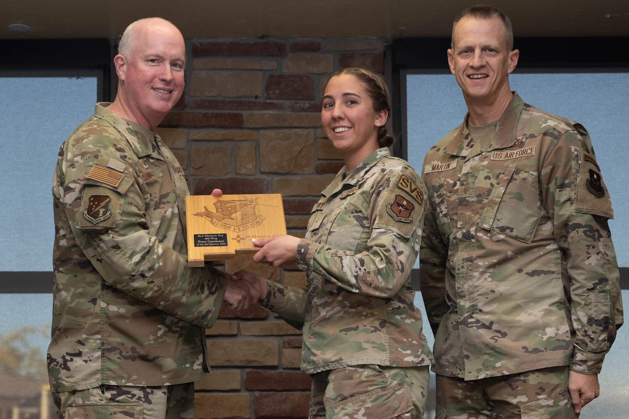 U.S. Air Force Senior Airman Melanie Fry from the 49th Force Support Squadron, accepts the Honor Guardsmen of the Quarter during the 49th Wing’s 3rd Quarter Award ceremony at Holloman Air Force Base, New Mexico, November 9, 2023. Quarterly award winners were selected based on their technical expertise, demonstration of leadership and job performance. (U.S. Air Force photo by Airman 1st Class Bob Teichmann)