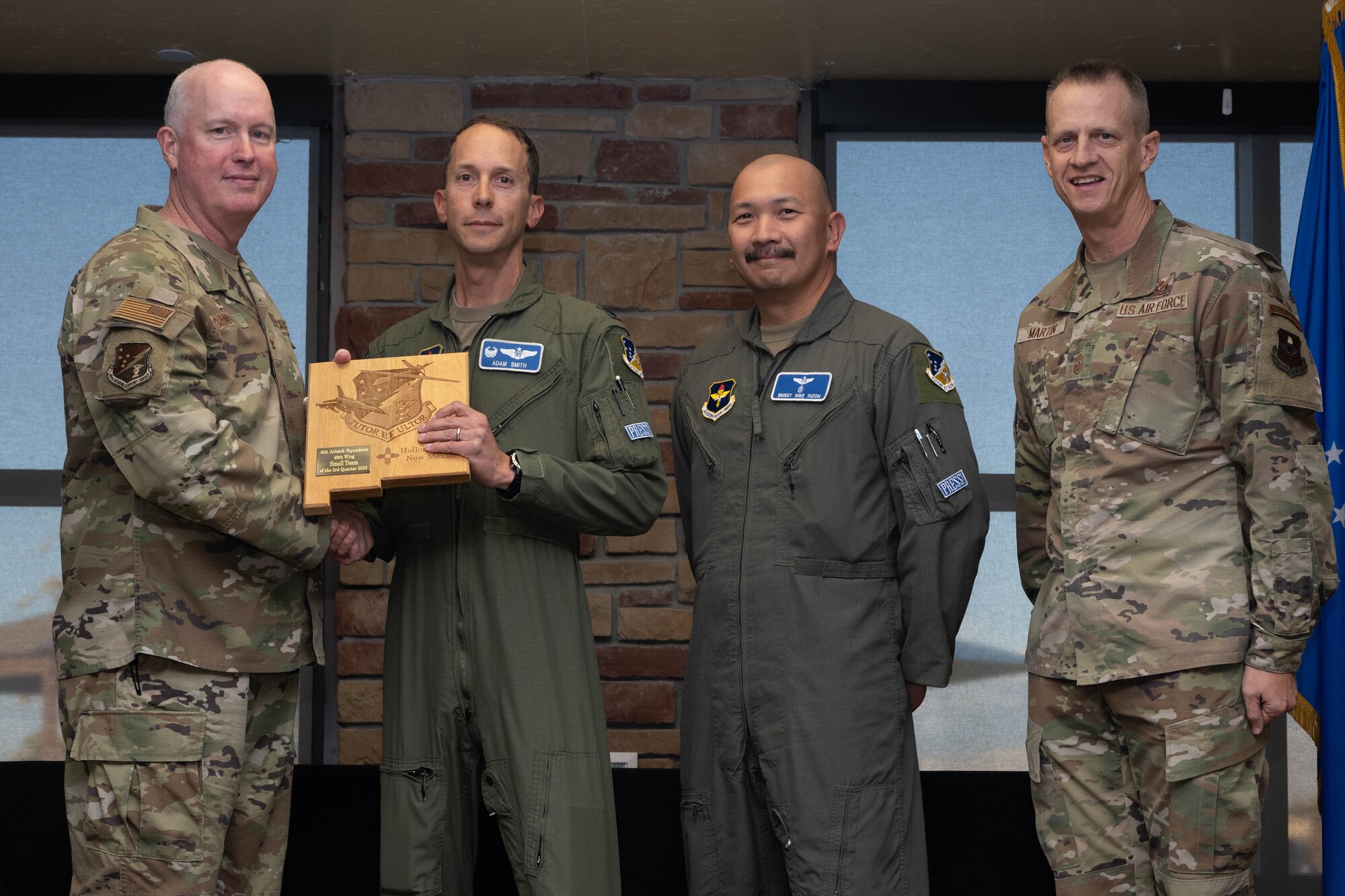 U.S. Air Force Lt. Col. Adam Smith, left, and Senior Master Sgt. Michael Dizon from the 6th Attack Squadron accept the Small Unit of the Quarter Award during the 49th Wing’s 3rd Quarter Award ceremony at Holloman Air Force Base, New Mexico, November 9, 2023. Quarterly award winners were selected based on their technical expertise, demonstration of leadership and job performance. (U.S. Air Force photo by Airman 1st Class Bob Teichmann)