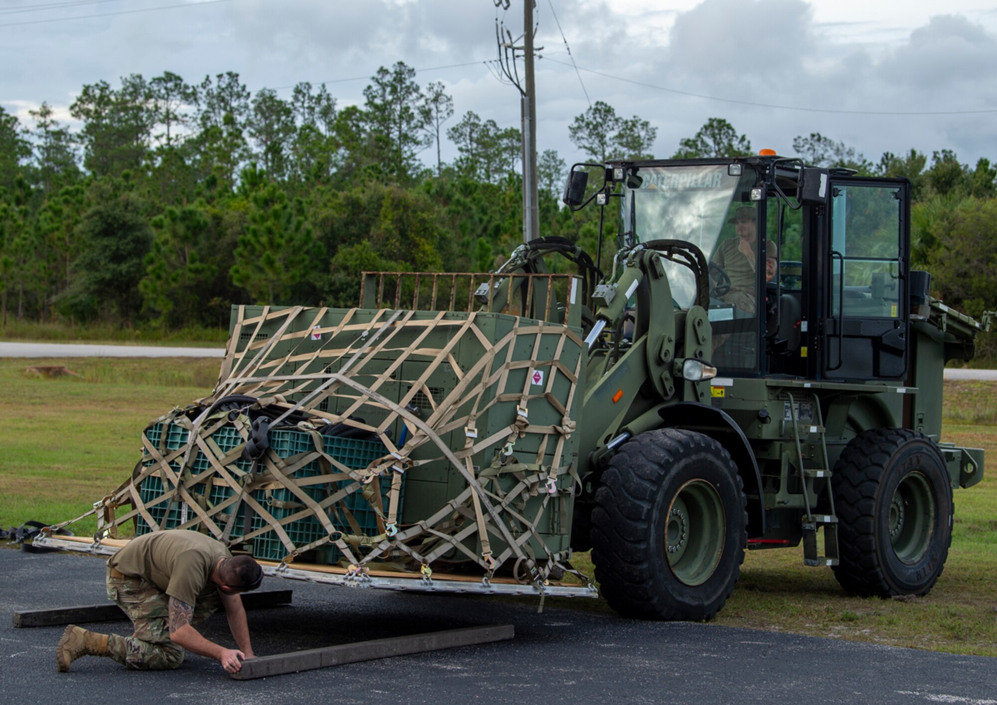 Mosaic Tiger participants move cargo at Avon Park Air Force Range, Florida, Nov. 13, 2023. Several structures must be constructed quickly and efficiently to support operations, including a command and control tent and field kitchen. (U.S. Air Force photo by Airman 1st Class Leonid Soubbotine)