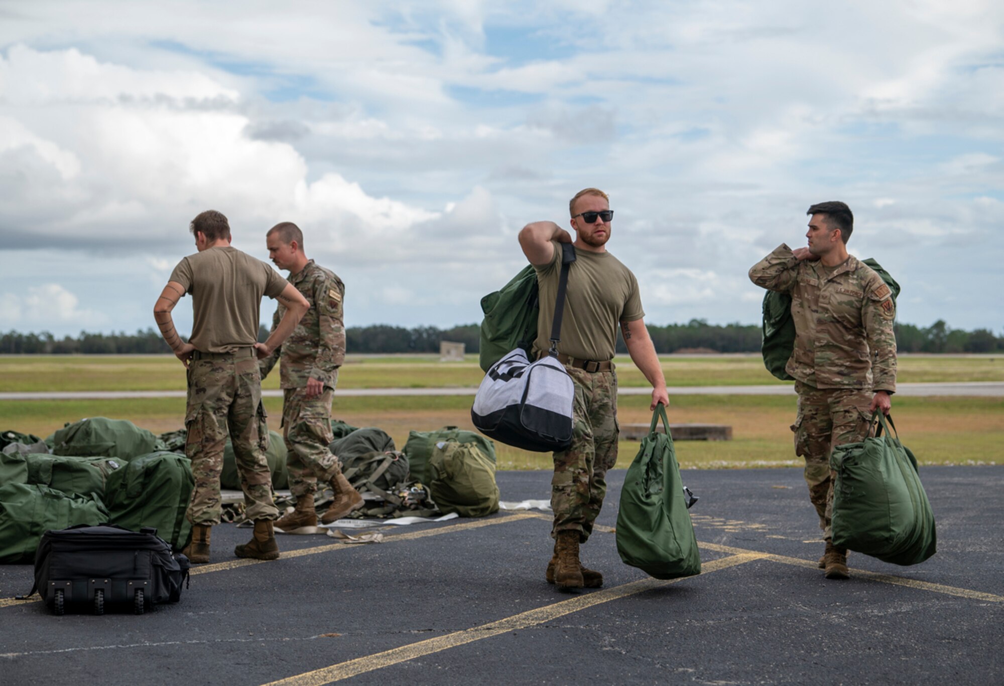 Mosaic Tiger participants unload their bags at Avon Park Air Force Range, Florida, Nov. 13, 2023. A C-17 Globemaster III assigned to the 437th Airlift Wing delivered the troops and cargo from Moody Air Force Base, Georgia. (U.S. Air Force photo by Airman 1st Class Leonid Soubbotine)