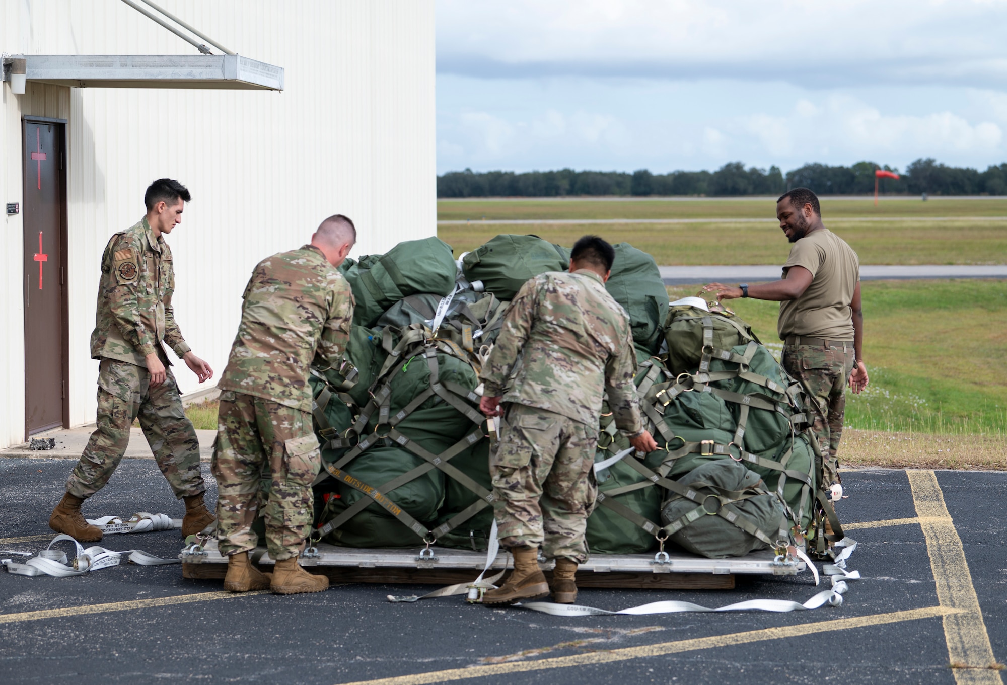Mosaic Tiger 24-1 participants prepare to unload duffel bags at Avon Park Air Force Range, Florida, Nov. 13, 2023. Mosaic Tiger tests the ability, speed and efficiency of rapid mobility to project combat power. (U.S. Air Force photo by Airman 1st Class Leonid Soubbotine)