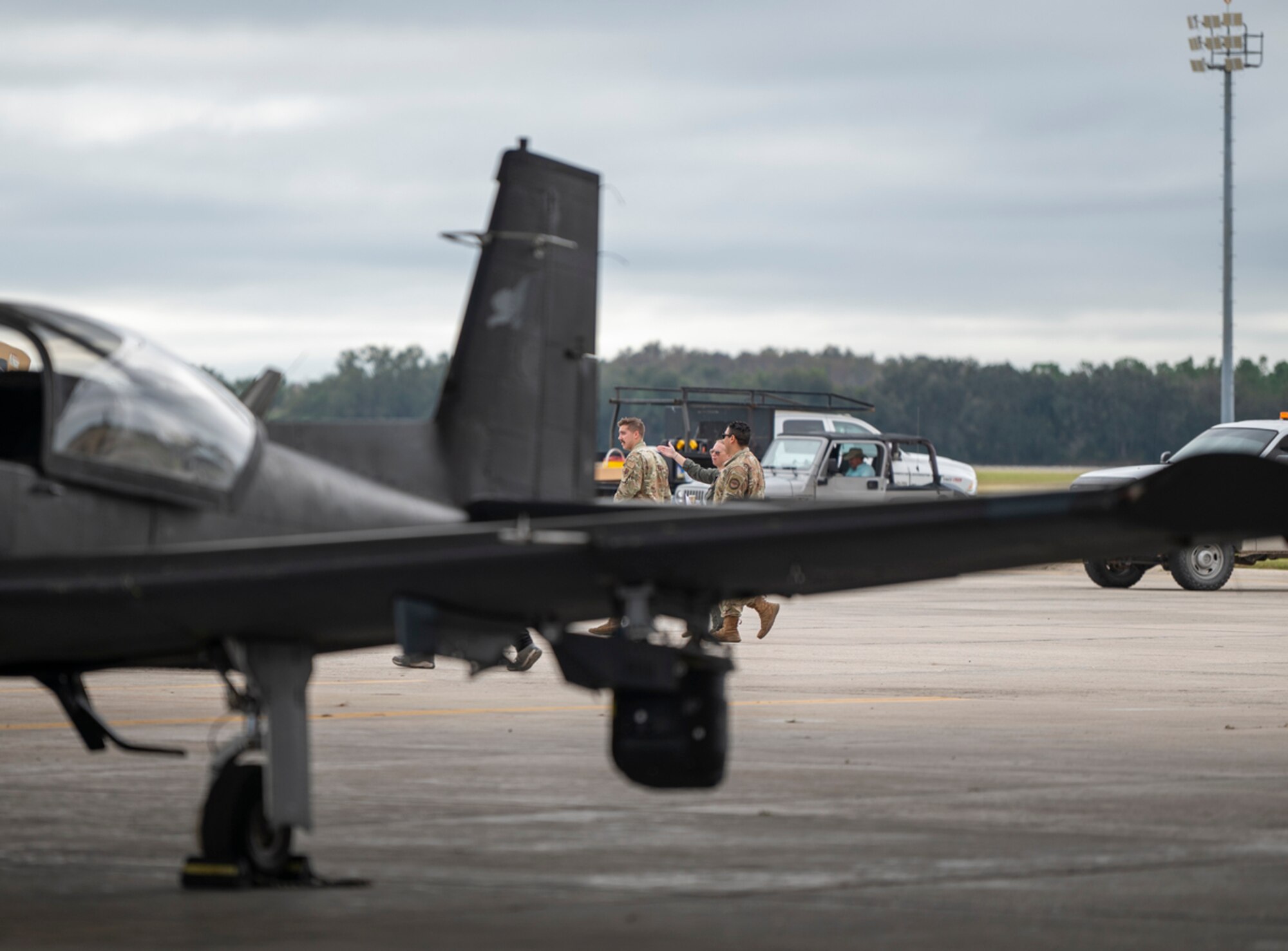 U.S. Air Force Airmen walk along the airfield at Avon Park Air Force Range, Florida, during exercise Mosaic Tiger 24-1 on Nov. 13, 2023. Mosaic Tiger is a command and control exercise designed to test and develop the ability to generate airpower at austere locations in challenging conditions. (U.S. Air Force photo by Airman 1st Class Leonid Soubbotine)