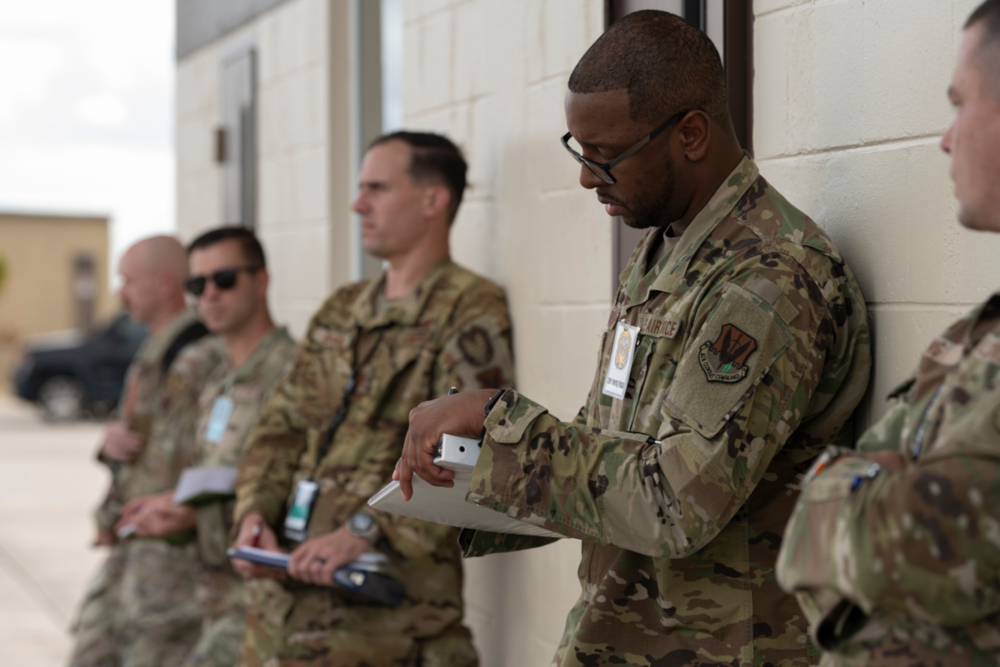 U.S. Air Force Tech. Sgt. Claudel Summers, 23rd Wing Inspector General inspector, takes notes during Mosaic Tiger 24-1 at Avon Park Air Force Range, Florida, Nov. 13, 2023. A team of inspectors are tasked with evaluating Airmen and their efficiency of operations during the exercise to determine their overall readiness. (U.S. Air Force photo by Senior Airman Rachel Coates)