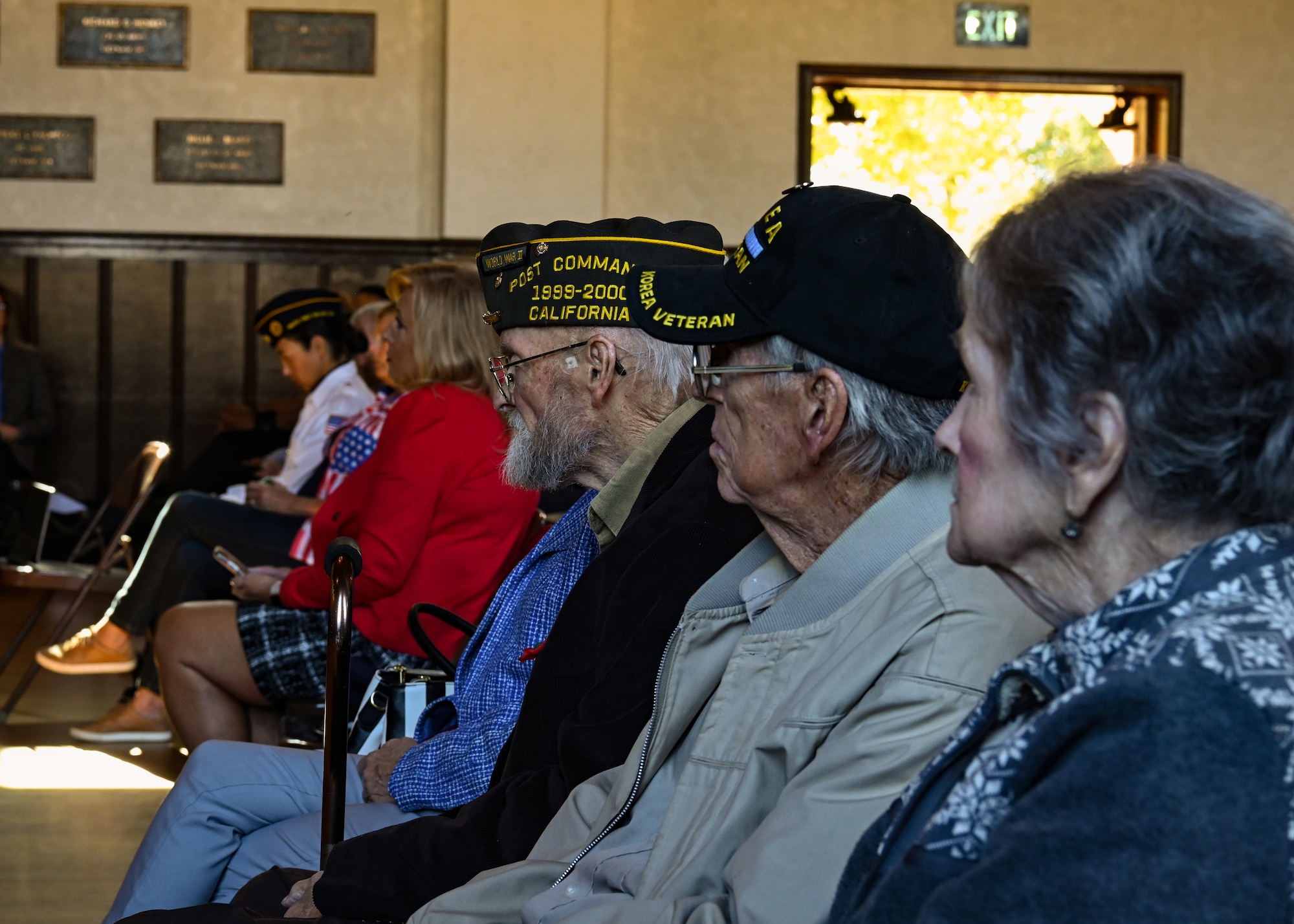 A Korean War and World War II veteran listen to the choir sing during the Veterans Day ceremony at the Solvang Veterans Memorial Hall.