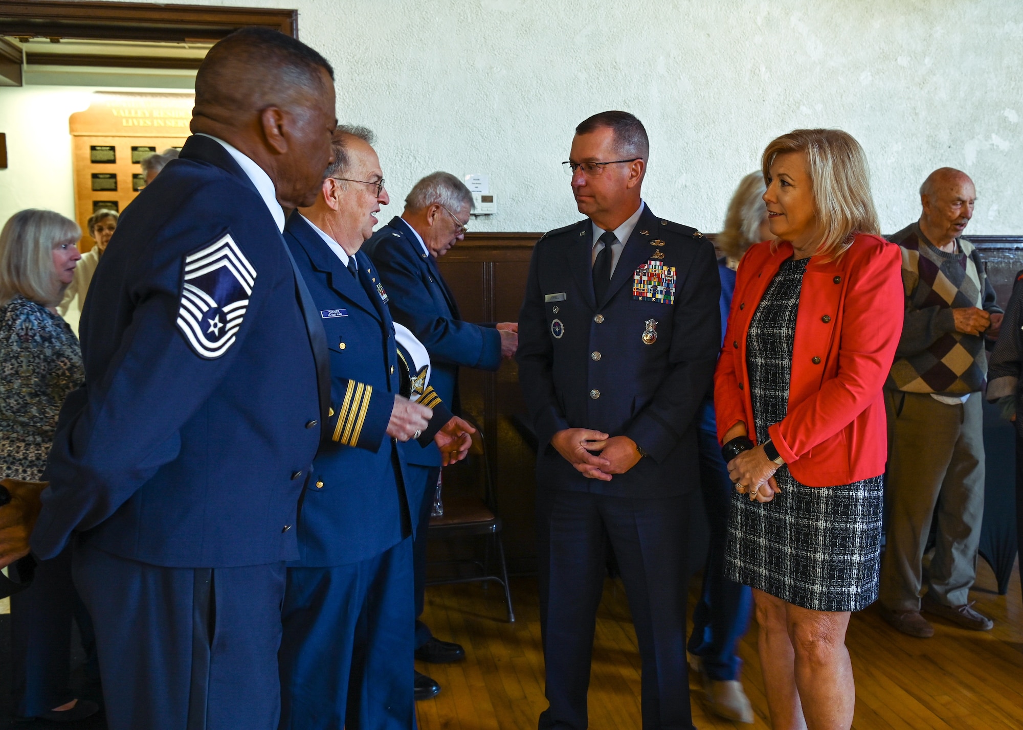 Space Launch Delta 30 vice commander, and his spouse, speaks with retired service members during the Veterans Day ceremony at the Solvang Veterans Memorial Hall.