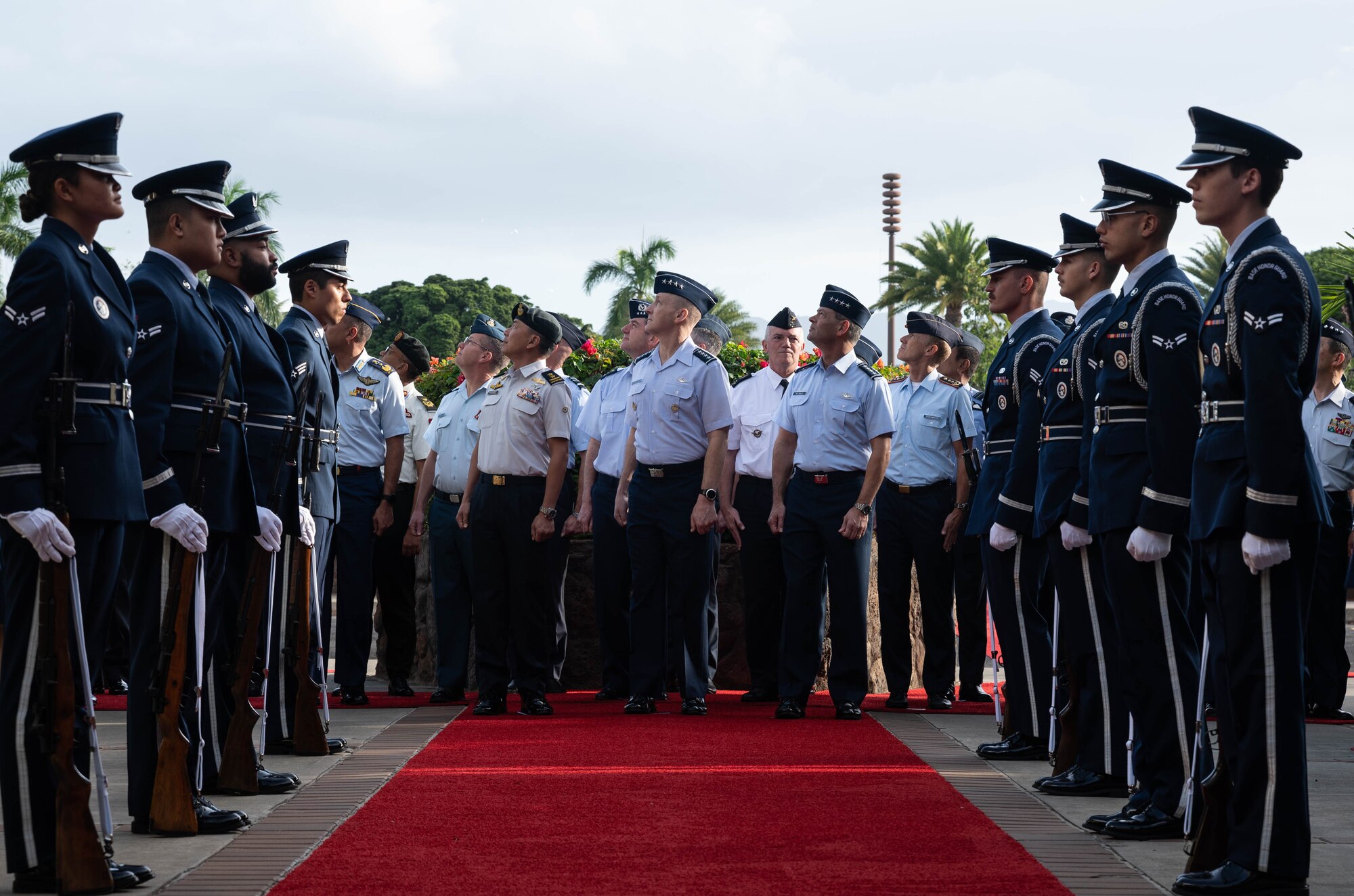 Air chiefs and senior enlisted leaders from more than 20 countries view a flyover during the opening ceremony of the Pacific Air Chiefs Symposium 2023 at Joint Base Pearl Harbor-Hickam, Hawaii, Nov. 14, 2023. The symposium provided an opportunity for senior leaders from around the globe to share regional perspectives through bilateral and multilateral engagements and panels. (U.S. Air Force photo by Staff Sgt. Alan Ricker)