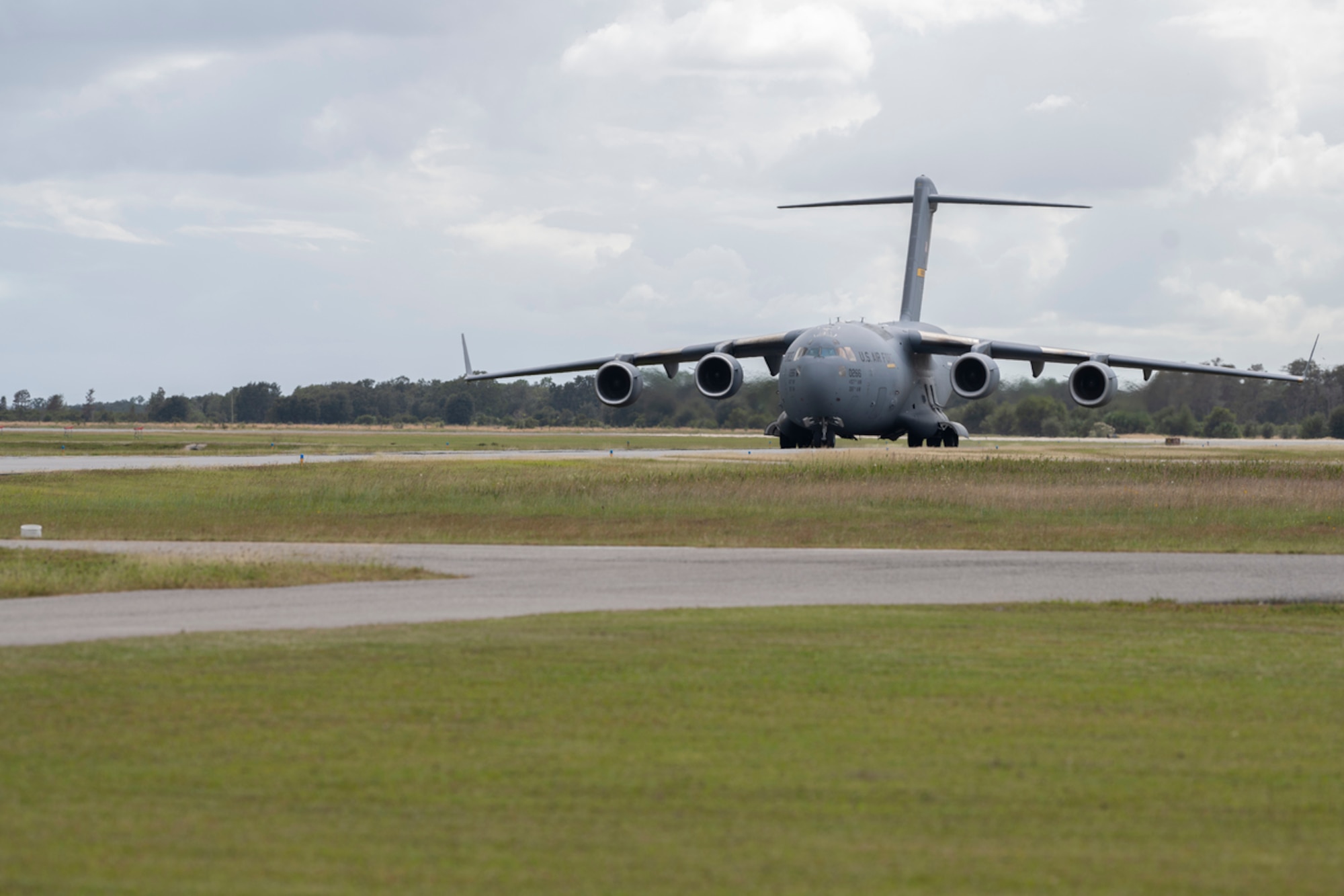 A C-17 Globemaster III assigned to the 437th Airlift Wing at Joint Base Charleston, South Carolina, taxis down a runway at Avon Park Air Force Range, Florida, Nov. 13, 2023. The aircraft transported Mosaic Tiger 24-1 participants and equipment in support of the weeklong agile-combat-employment exercise. (U.S. Air Force photo by Senior Airman Rachel Coates)
