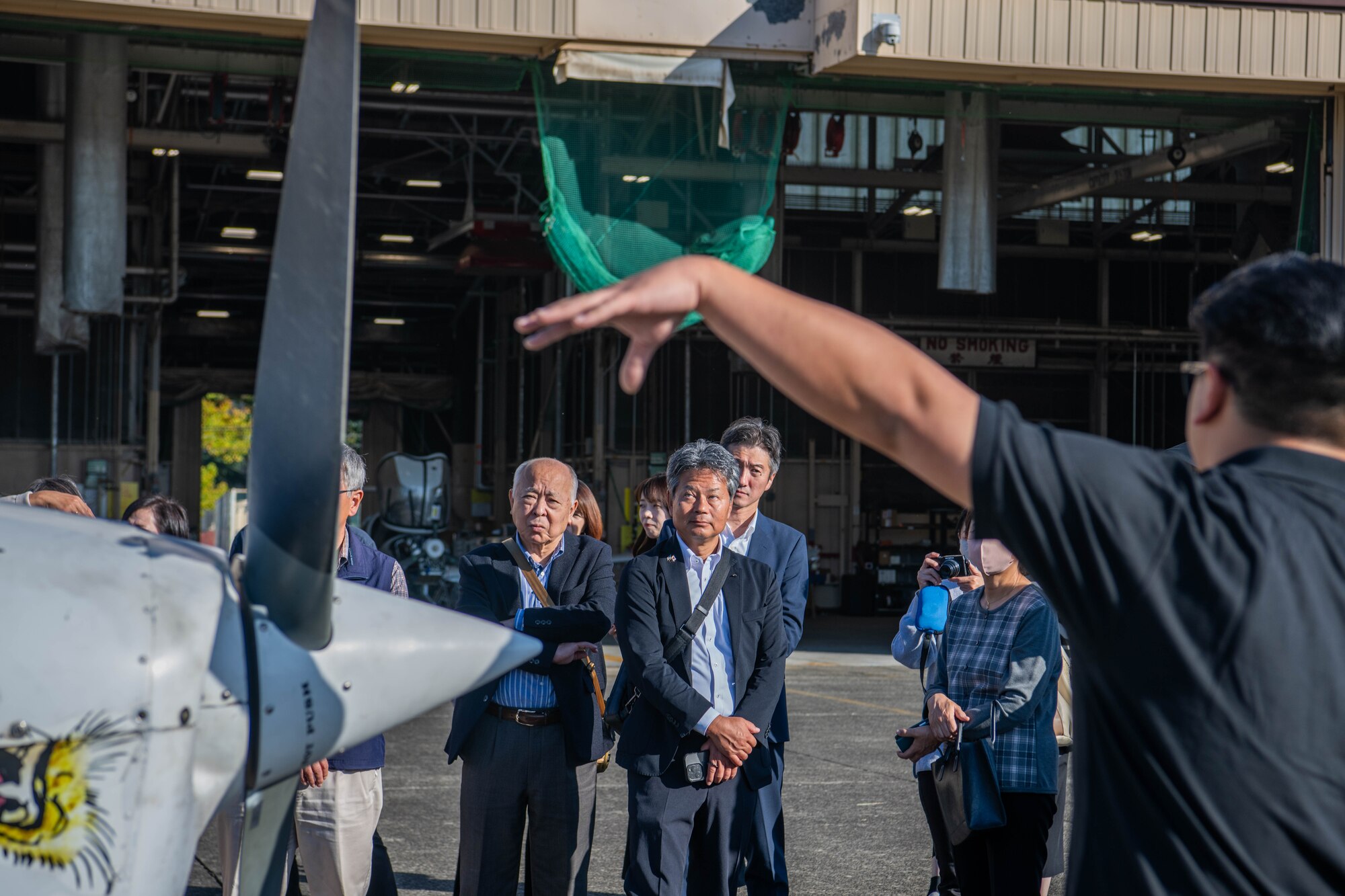 Members of the Akishima-Yokota Friendship Club listen to a briefing.