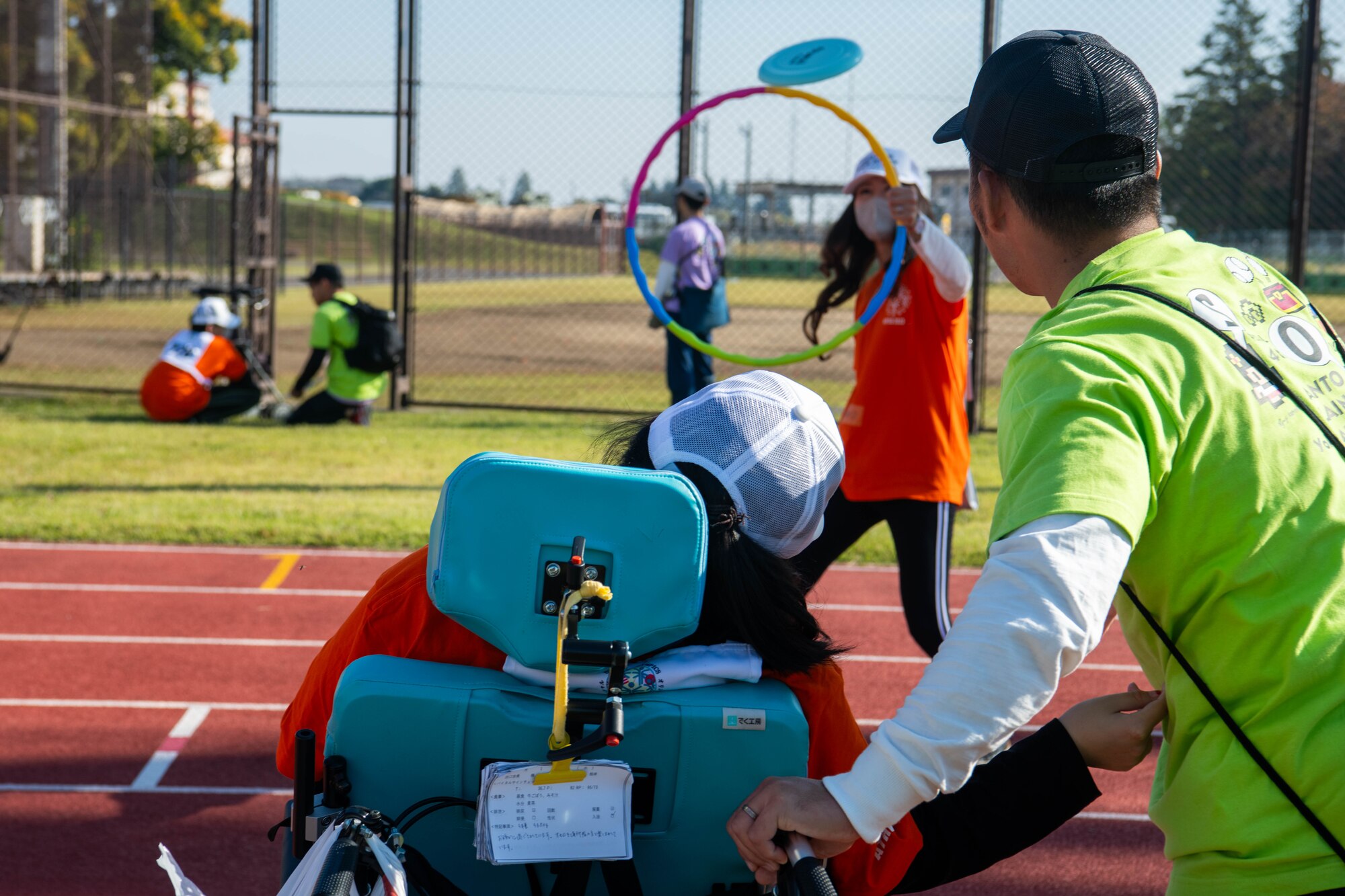 Athletes and their coaches practice for the flying disc competition.