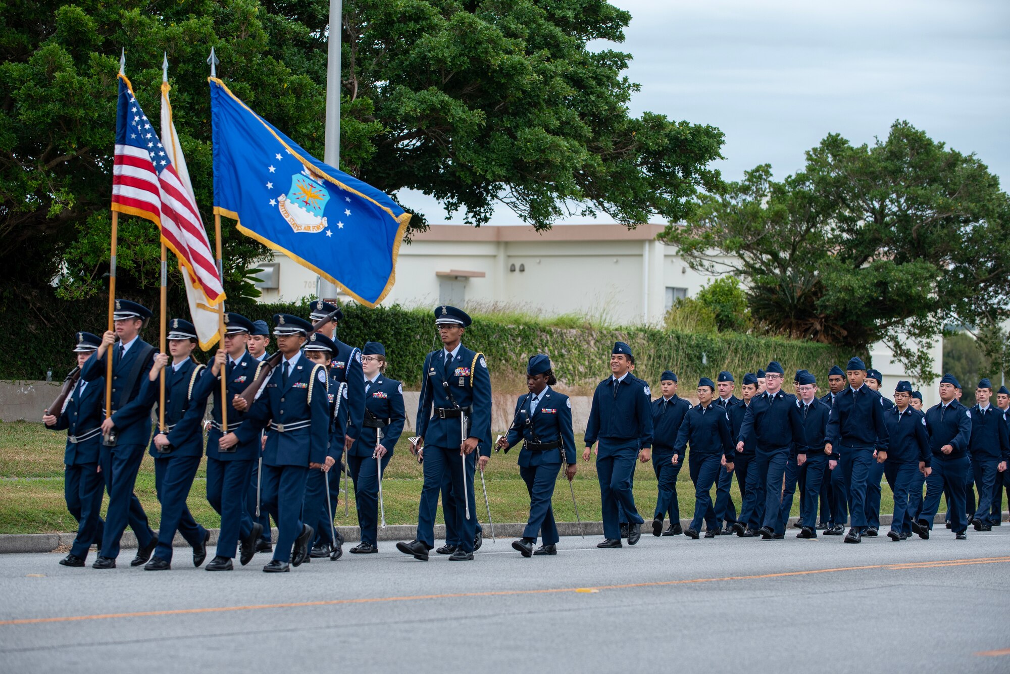 Base honor guard and JROTC students from Kadena Air Base lead the base's Veterans day parade