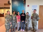 U.S. Air Force Senior Airman Matilyn Million, 6th Medical Support Squadron laboratory technician, stands next to her coworkers during a chemotherapy appointment in Tampa, Florida, Aug. 21, 2023.