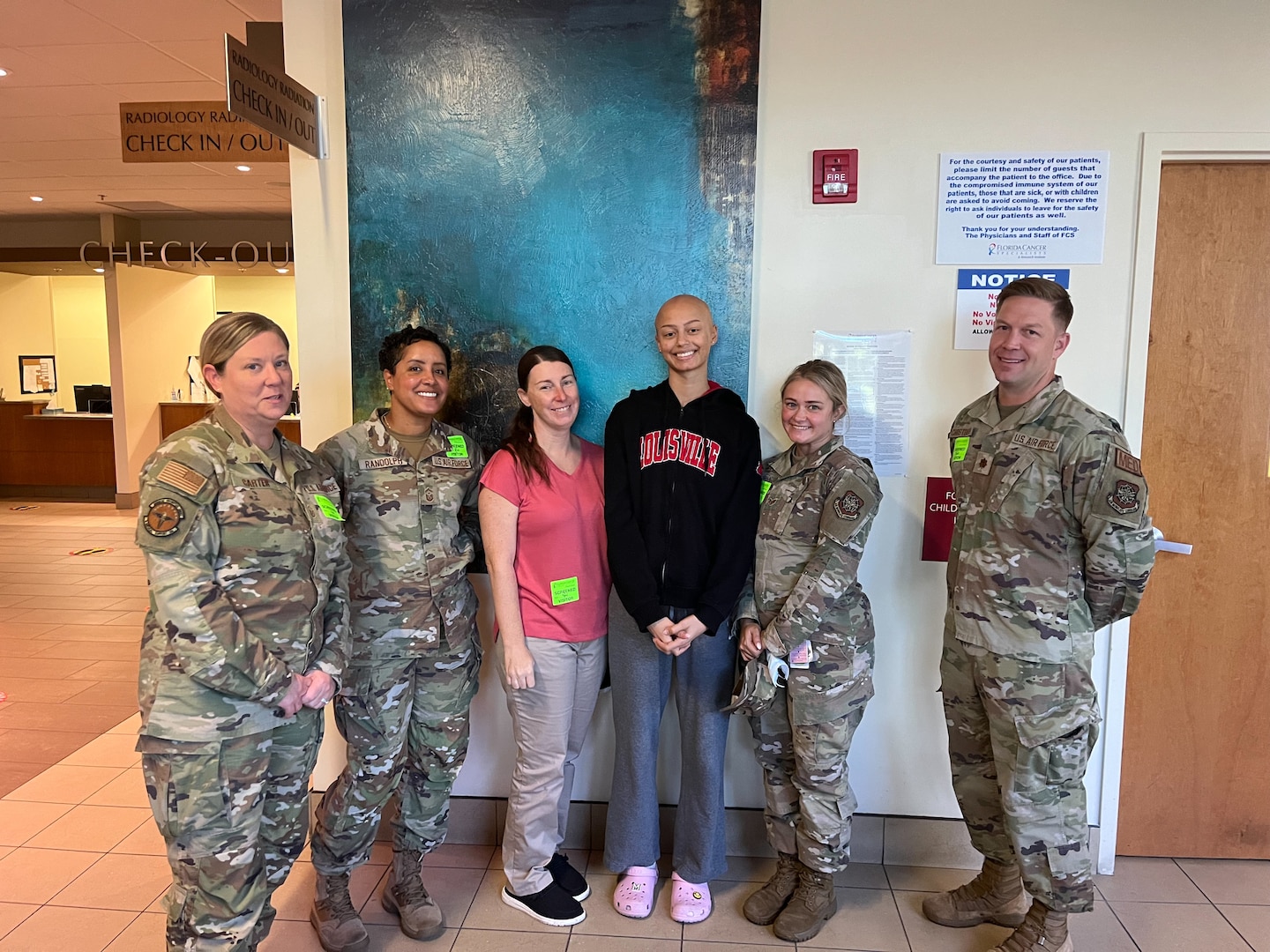 U.S. Air Force Senior Airman Matilyn Million, 6th Medical Support Squadron laboratory technician, stands next to her coworkers during a chemotherapy appointment in Tampa, Florida, Aug. 21, 2023.