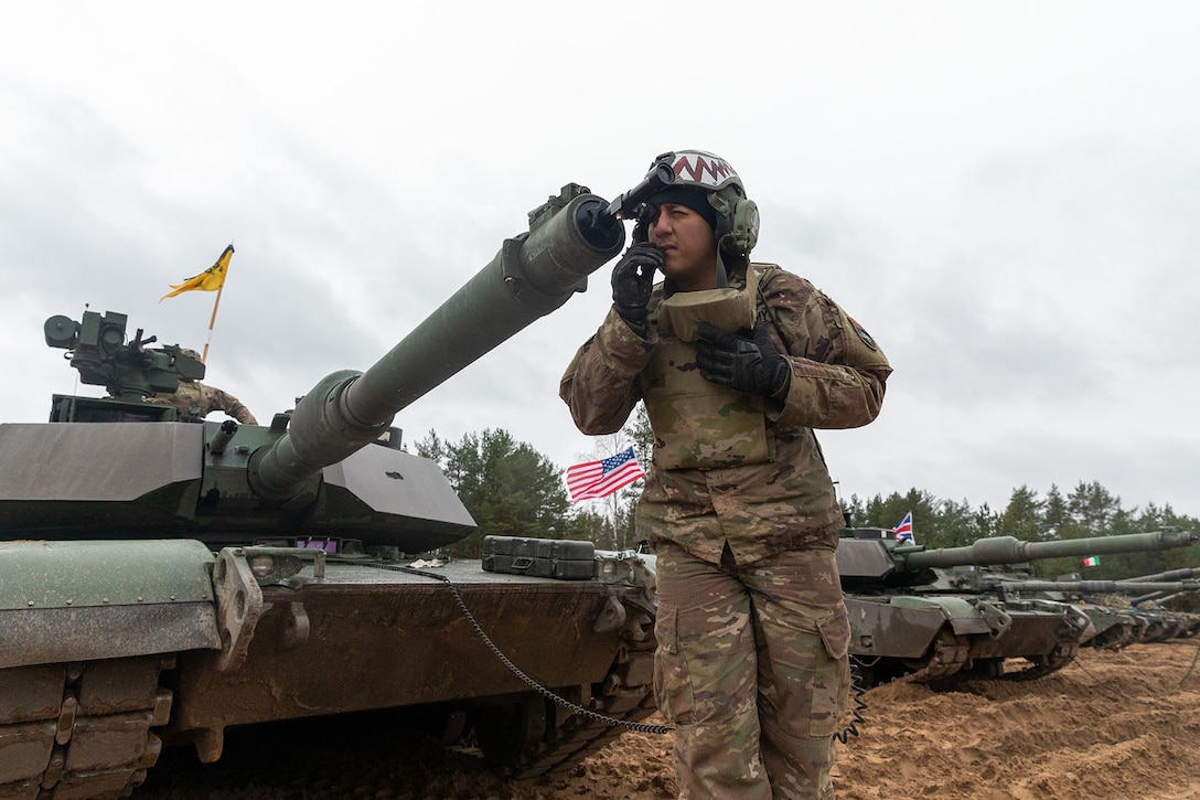 A soldier boresights an M1A2 Abrams main gun.