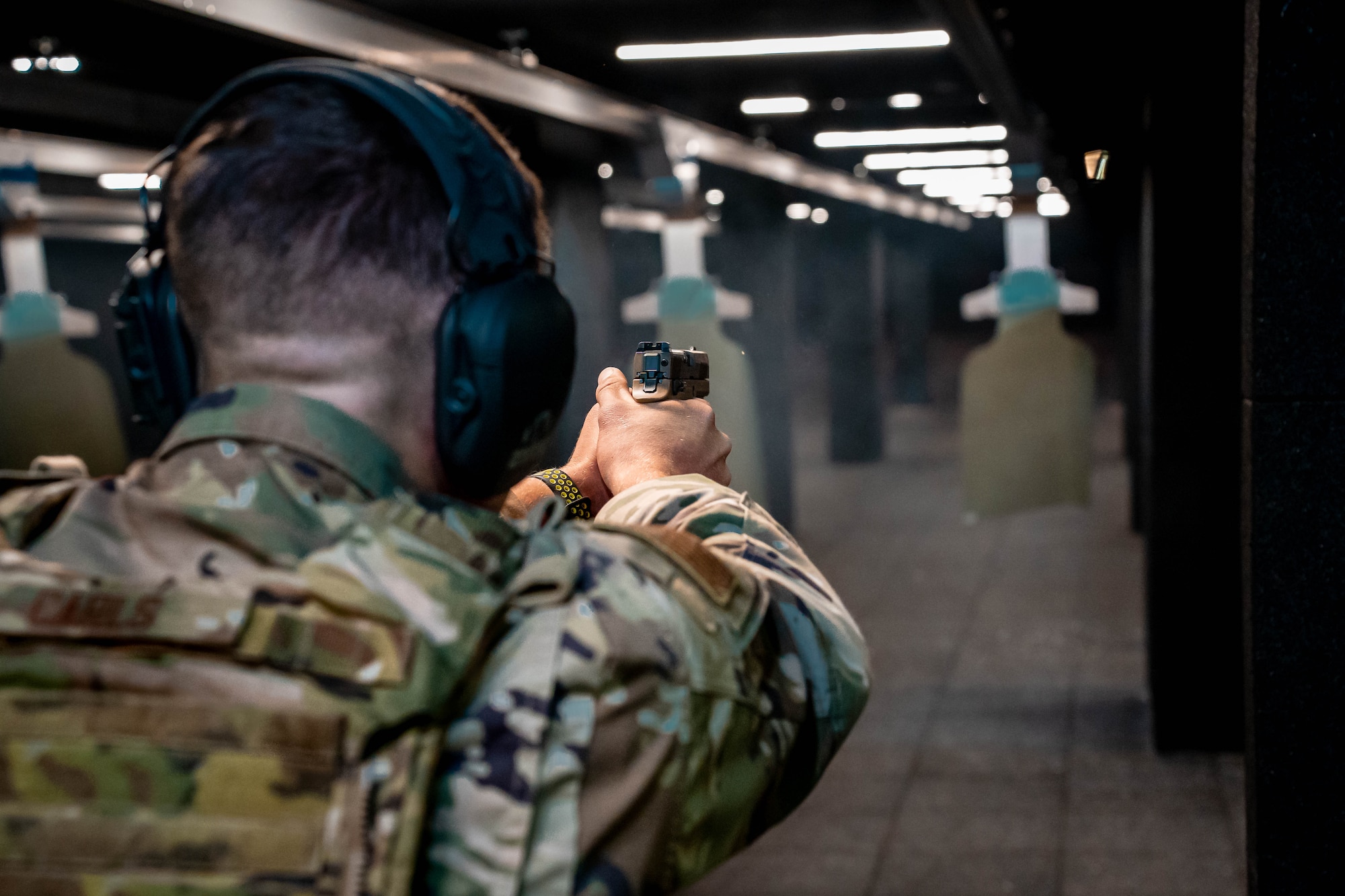 Senior Airman Chase Carls, defender with the 114th Security Forces Squadron, fires the M18 Modular Handgun System during the Defender Qualification Course (DQC) at Joe Foss Field, South Dakota, Nov. 4, 2023.