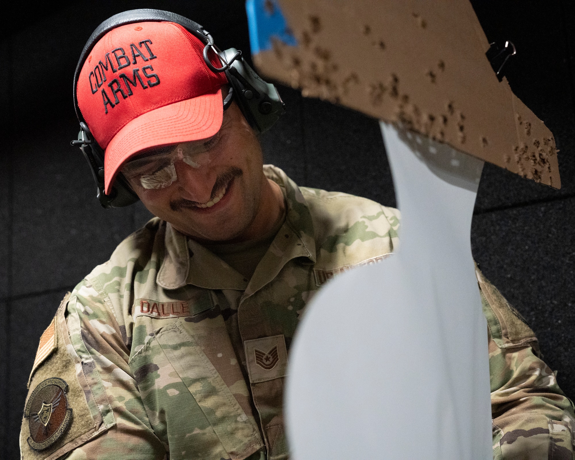 U.S. Air Force Tech. Sgt. Marcos Dalle, combat arms training and maintenance instructor with the 114th Security Forces Squadron, scores a target during a M18 handgun qualification course at Joe Foss Field, South Dakota, Nov. 4, 2023.