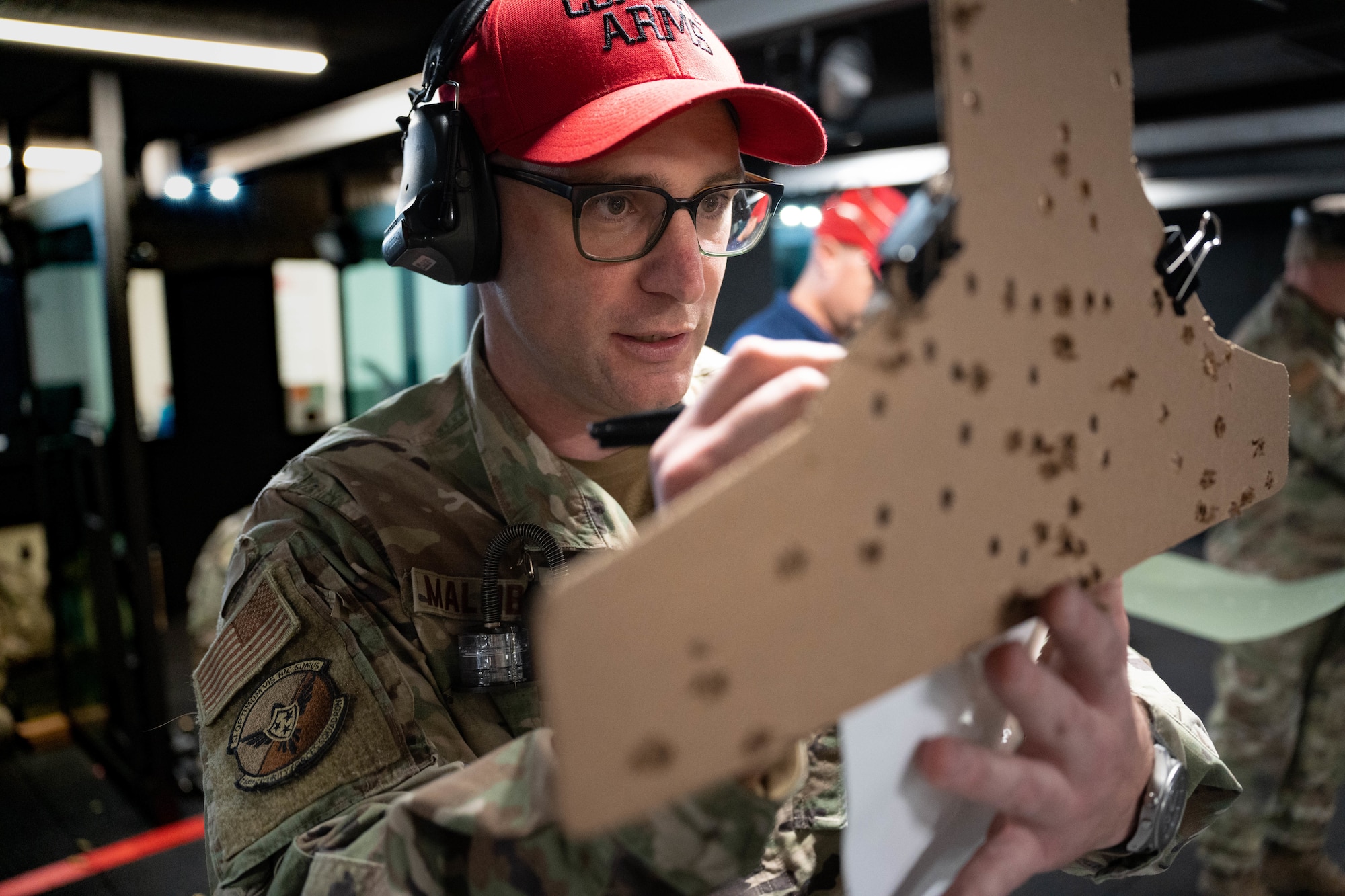 U.S. Air Force Master Sgt. Daniel Malmberg, combat arms training and maintenance instructor with the 114th Security Forces Squadron, scores a target during a M18 handgun qualification course at Joe Foss Field, South Dakota, Nov. 4, 2023.