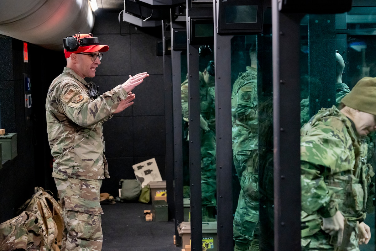 U.S. Air Force Master Sgt. Daniel Malmberg, combat arms training and maintenance instructor with the 114th Security Forces Squadron, gives instruction during a M18 handgun qualification course at Joe Foss Field, South Dakota, Nov. 4, 2023.