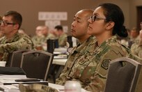 2nd Lt. William Bounthong of Roscoe, Illinois, and Sgt. 1st Class Isaura Islas of Chicago, both from the 108th Multi-Functional Medical Battalion Detachment, listen to Maj. Gen. Rodney Boyd, the Commander of the Illinois Army National Guard, during the Illinois Army National Guard Commander's Guidance Seminar.