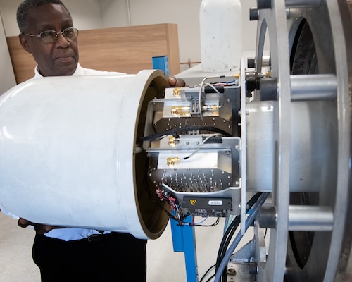 A technician encloses an antenna system.