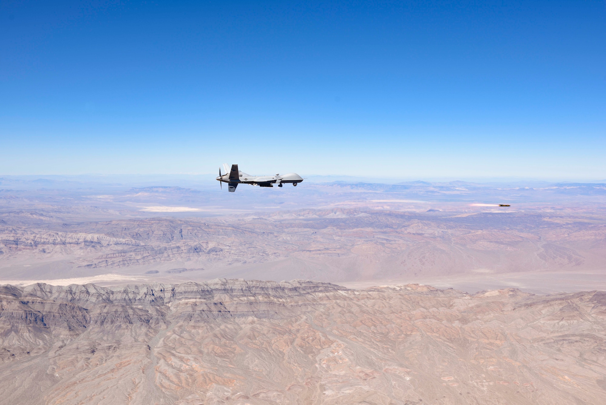 An MQ-9 Reaper fires a Hellfire Missile.