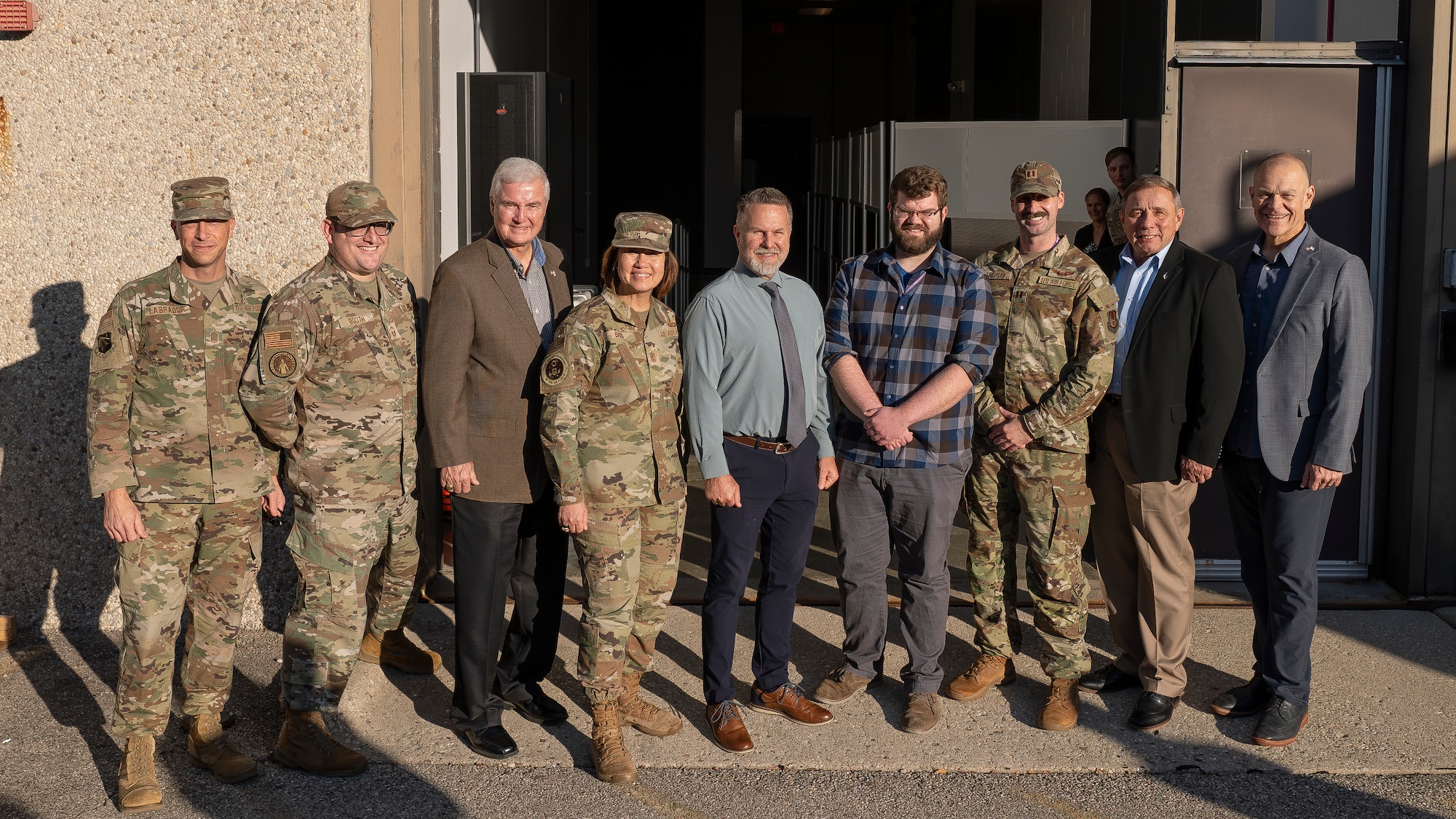 Chief Master Sgt. of the Air Force JoAnne Bass, fourth from left, stands with Airmen and other distinguished visitors  following a drone program brief during a visit to Wright-Patterson Air Force Base Nov. 9, 2023. During the visit, Bass toured the Air Force Research Laboratory’s 711th Human Performance Wing . (U.S. Air Force photo / Keith Lewis)