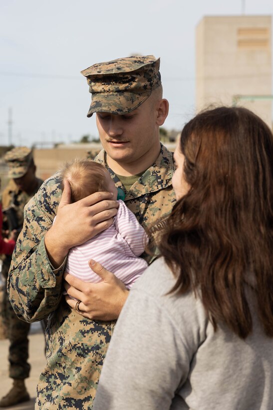 A U.S. Marine with 3rd Low Altitude Air Defense Battalion, Marine Air Control Group 38, 3rd Marine Aircraft Wing, embraces his daughter before departing in support of the Unit Deployment Program (UDP) and 31st Marine Expeditionary Unit at Marine Corps Base Camp Pendleton, California, Nov. 10, 2023. The mission of 3rd LAAD is to enhance unit readiness and provide flexible low altitude air defense capabilities in support of a forward-posture in the Indo-Pacific region. This will be the last rotation 3rd LAAD supports the 31st MEU before transferring responsibility to 1st LAAD in line with Force Design 2030. (U.S. Marine Corps photo by Lance Cpl. Alexis Ibarra)
