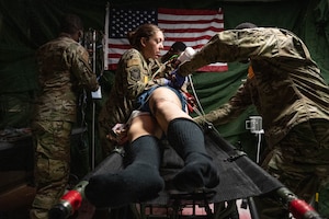 Airmen from the 934th Aeromedical Staging Squadron turn a mannequin over during a training exercise on Oct. 15, 2023 at Regions Hospital in St. Paul, Minnesota. The exercise involved realistic wounds and training equipment to simulate a true combat casualty care enviornment. (U.S. Air Force photo by Senior Airman Victoriya Tarakanova)