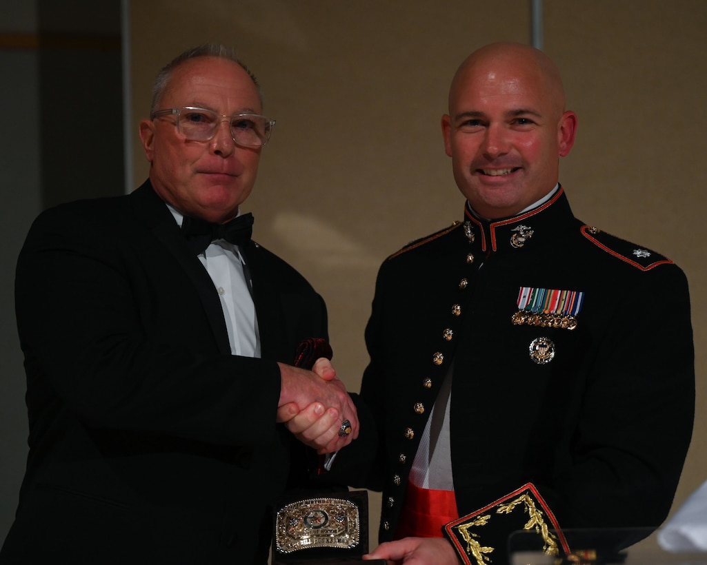 U.S. Marine Corps Lt. Col. Thomas A. Coyle, Marine Corps Detachment Goodfellow Commanding Officer, presents a gift to the guest of honor, Master Sgt. William Bockelman II, retired, at the  248th Marine Corps Birthday Ball held at the McNease Convention Center, San Angelo, Texas, Nov. 10, 2023. Since 1921, the Marine Corps has celebrated its birthday and honored the legacy of Marines at the Marine Corps Ball.