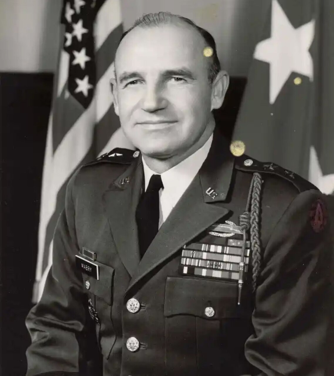 A man in dress uniform poses for a photo.