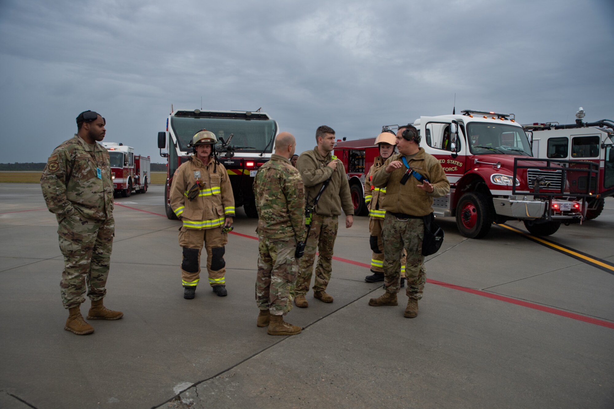 U.S. Air Force Staff Sgt. Concepcion Rodelo, 74th Fighter Generation Squadron weapons load crew member, walks the 23rd Civil Engineer Squadron Fire Department crew through the scenario during their response to a simulated dropped munition emergency call on the flightline during exercise Mosaic Tiger 24-1 at Moody Air Force Base, Georgia, Nov. 14, 2023. Dropped munitions are a rare occurrence, but there are tactics, techniques and procedures for Airmen to follow to ensure the safety of the aircrew and aircraft. (U.S. Air Force photo by Andrea Jenkins)