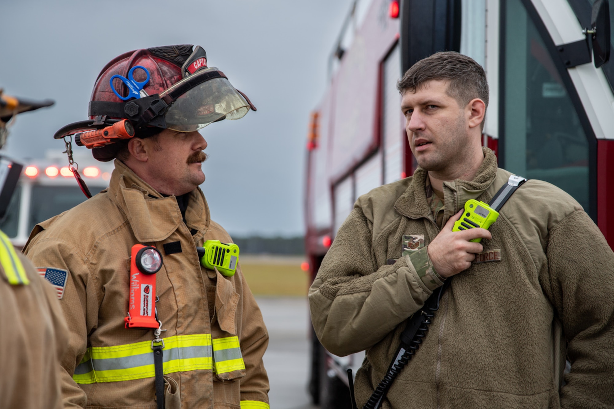 Members of the 23rd Civil Engineer Squadron Fire Department discuss the outcome of a simulated dropped munition emergency call during exercise Mosaic Tiger 24-1 at Moody Air Force Base, Georgia, Nov. 14, 2023. After the Airmen complete all the required tasks for the scenario inject, evaluators provide recommended areas of improvement or comment on best practices. (U.S. Air Force photo by Andrea Jenkins)