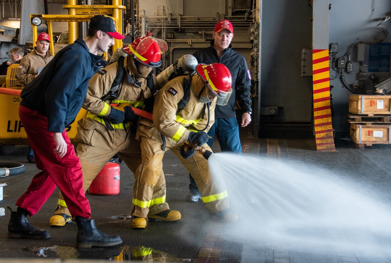 Firefighter spray a hose.