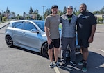 Evan Beckerman (left), Hull Technician 1st Class Justin Reinhardt (center), and Gary King Jr. (Right) stand in front of Reinhardt’s car prior to the remodel.