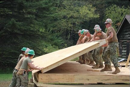 BOSWELL PA (Nov. 5, 2023) U.S. Navy Seabees assigned to Construction Battalion Maintenance Unit (CBMU) 202 construct a cabin in Boswell, Pennsylvania for a local outdoor leadership non-profit organization, Outdoor Odyssey, as part of the Department of Defense’s innovative readiness training program. The IRT program delivers hands-on training opportunities to military units to increase their deployment readiness while providing key services, like construction capabilities, to American communities. CBMU 202, is a subordinate command to Navy Expeditionary Combat Command, who mans, trains, equips, organizes and sustains their forces to bridge the gap from sea to shore and provide expeditionary capabilities in remote, complex and austere environments.