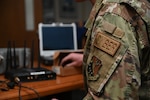 A U.S. Air National Guard Cyber Security Operations specialist assigned to the 148th Fighter Wing, Minnesota Air National Guard, inspects electrical components for radio communication at the Duluth, Minn., Air National Guard Base on Mar. 07, 2023. Cyber Security Operations specialists provide the best and most secure systems and ensure they operate properly while remaining secure from outside intrusion. (Air National Guard Photo by Airman 1st Class Tylin Rust)