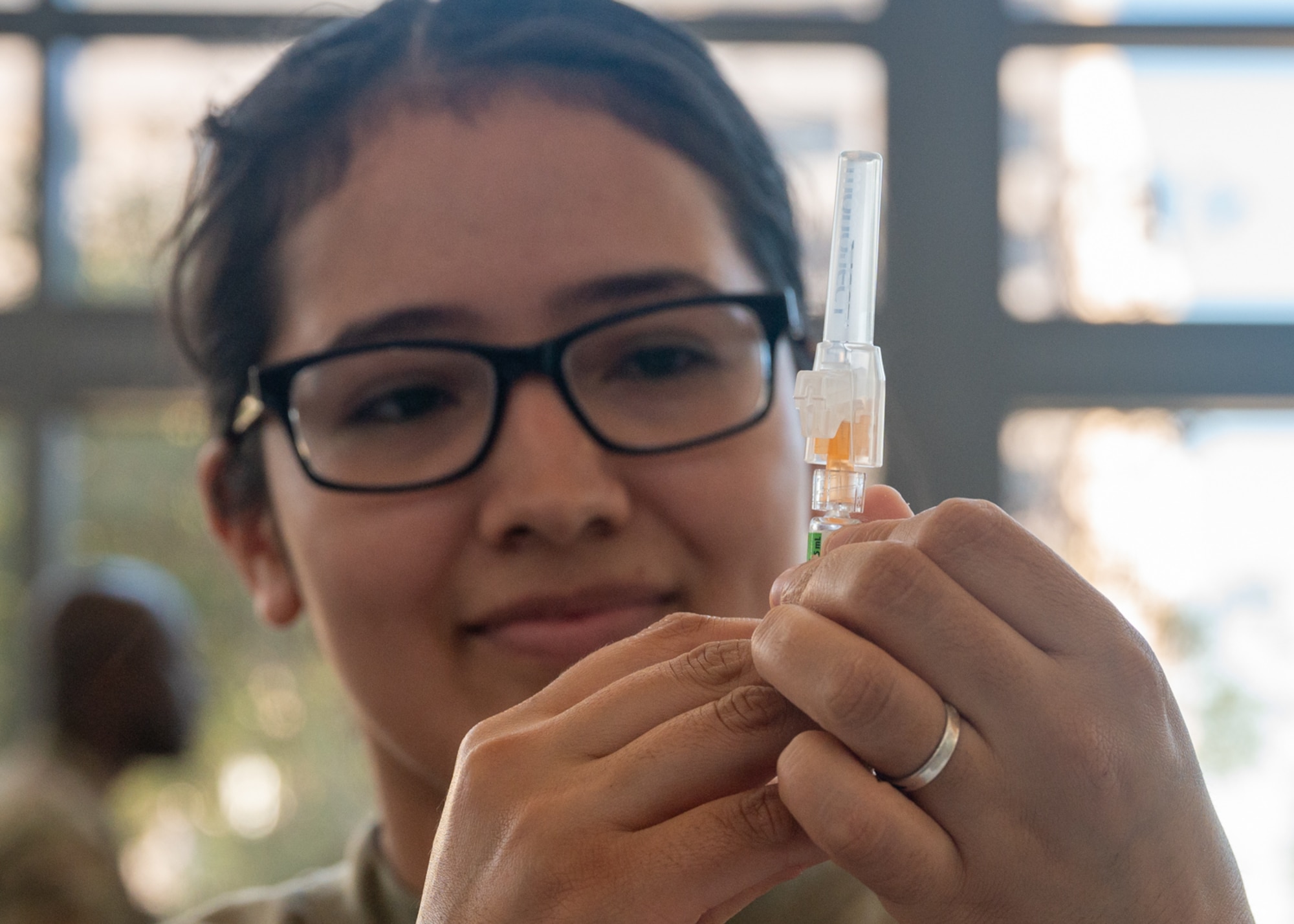 Tech. Sgt. Carolina Guzman, 59th Medical Specialty Squadron Allergy and Immunizations section chief, prepares an influenza vaccine on Nov. 14, 2023, at Wilford Hall Ambulatory Surgical Center, Joint Base San Antonio-Lackland, Texas. Airman from multiple clinics and specialties volunteered to ensure the 59th Medical Wing surpasses the Department of Defense’s 90-percent vaccination goal and protect against influenza and potential complications. (U.S. Air Force photo by Senior Airman Melody Bordeaux)