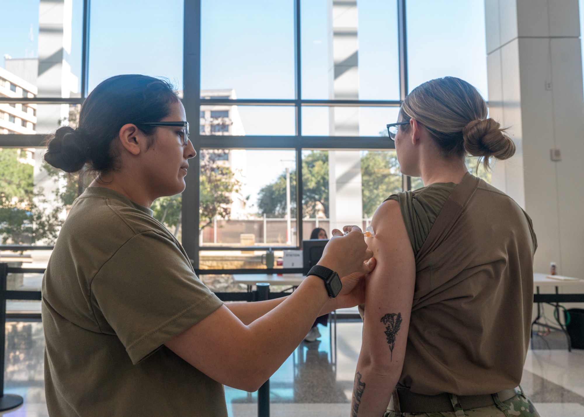 Tech Sgt. Carolina Guzman, 59th Medical Specialty Squadron Allergy and Immunizations section chief, vaccinates a patient with the influenza vaccine on Nov. 14, 2023, at Wilford Hall Ambulatory Surgical Center, Joint Base San Antonio-Lackland, Texas. Active duty can walk-in to receive their influenza vaccine in the WHASC atrium between the C and D wings. (U.S. Air Force photo by Senior Airman Melody Bordeaux)