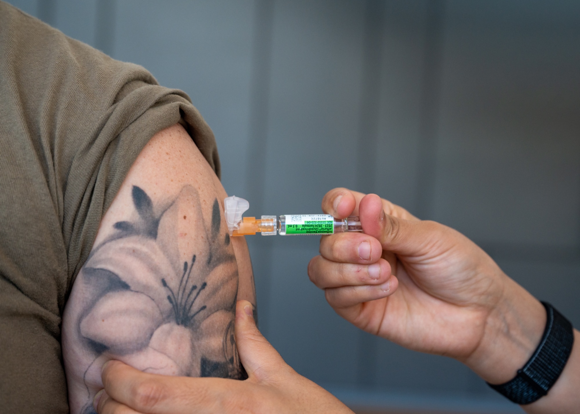 A patient is vaccinated with the influenza vaccine on Nov. 14, 2023, at Wilford Hall Ambulatory Surgical Center, Joint Base San Antonio-Lackland, Texas. Active duty can walk-in to receive their influenza vaccine in the WHASC atrium between the C and D wings. (U.S. Air Force photo by Senior Airman Melody Bordeaux)