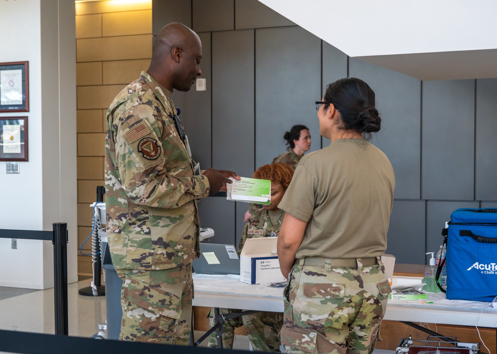 Master Sgt. Evans Opoku, 59th Medical Specialty Squadron Allergy and Immunizations Clinic flight chief, discusses the influenza vaccine with Tech. Sgt. Carolina Guzman, 59th Medical Specialty Squadron Allergy and Immunizations section chief, on Nov. 14, 2023, at Wilford Hall Ambulatory Surgical Center, Joint Base San Antonio-Lackland, Texas. Vaccination can significantly reduce influenza illnesses, doctors’ visits, missed work attendance, and prevent flu-related hospitalizations. (U.S. Air Force photo by Senior Airman Melody Bordeaux)