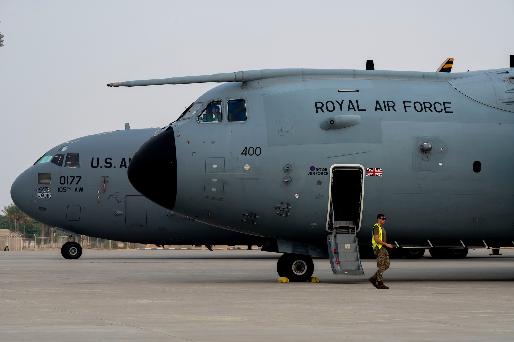 A Royal Air Force A400M Atlas and a U.S. Air Force C-17 Globemaster III are parked on the flightline.