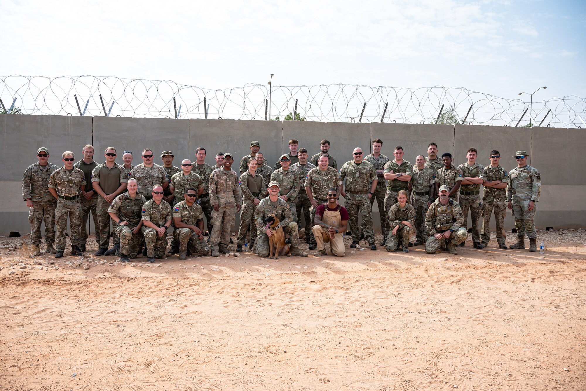 U.S. Air Force Airmen assigned to the U.S. Central Command Area of Responsibility conduct a K-9 demonstration with British Army personnel.
