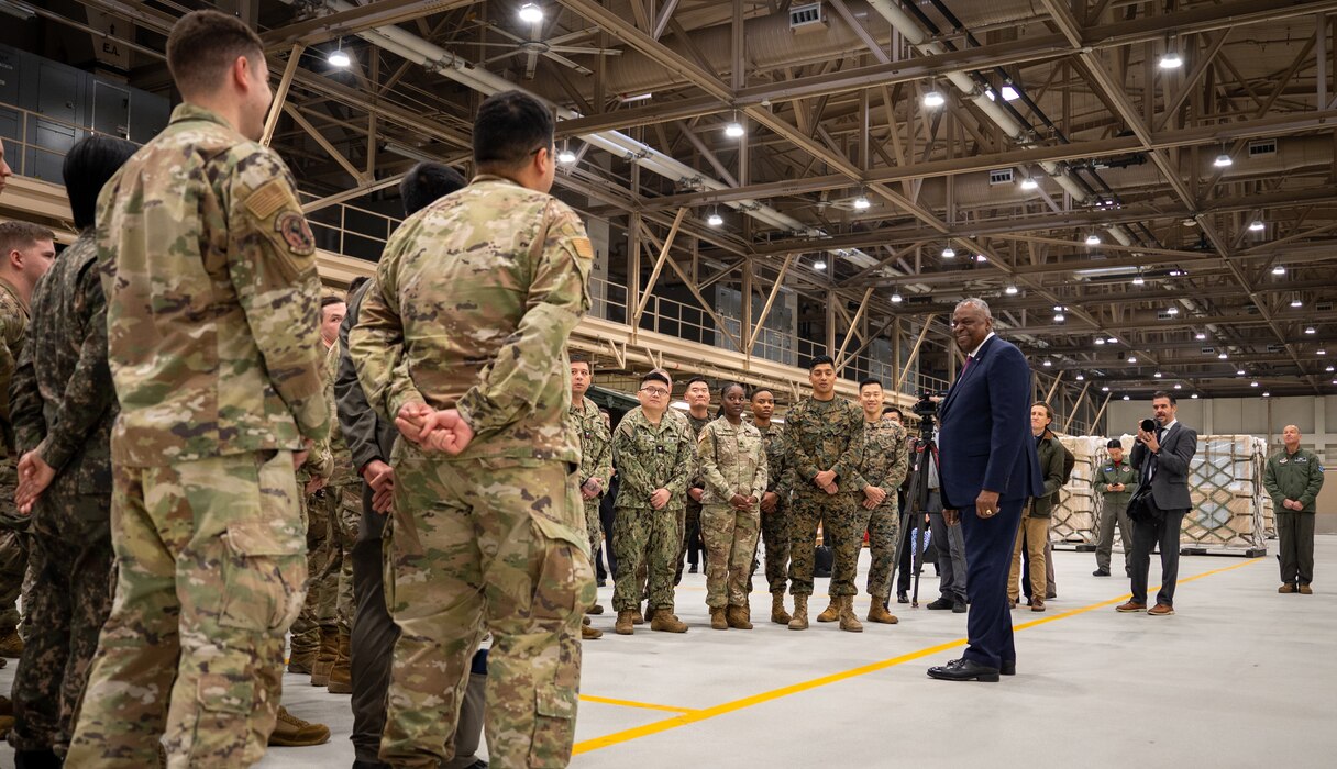 Secretary of Defense Lloyd J. Austin III engages with service members.