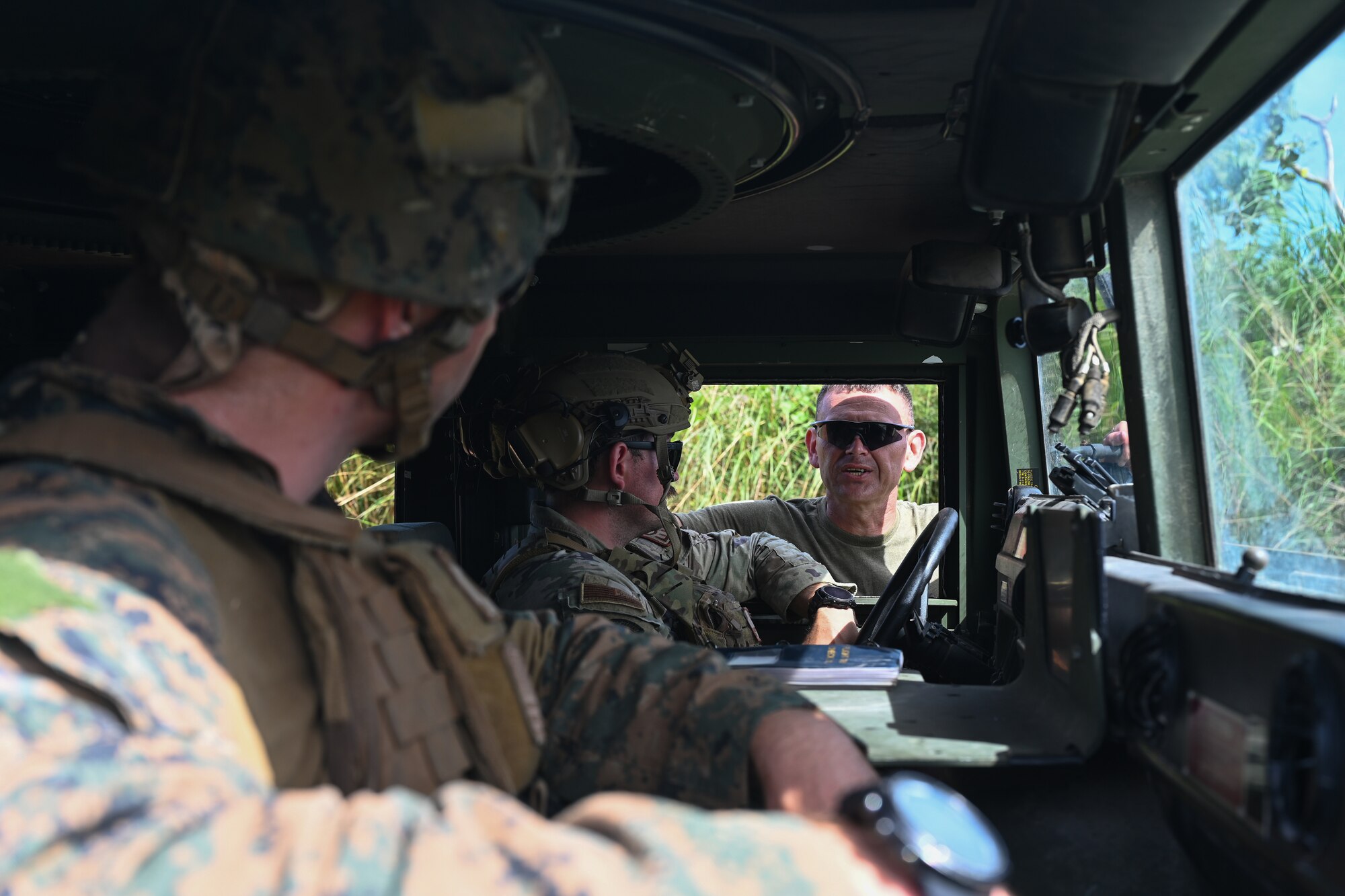 A U.S. Air Force airman and a U.S. Marine Corps marine speak with a marine training instructor during an explosive ordinance training at Andersen Air Force Base, Guam, Nov. 8, 2023.
