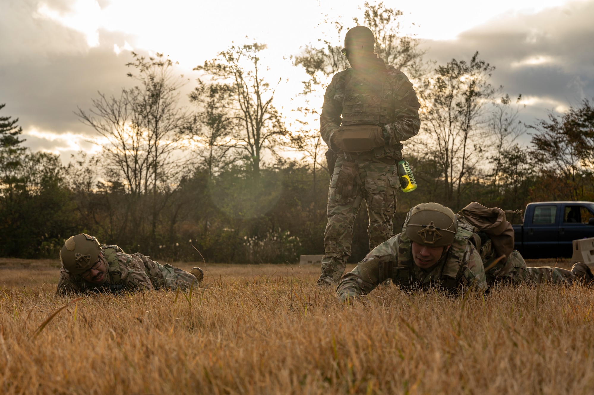 Airmen perform low crawl during a training exercise.