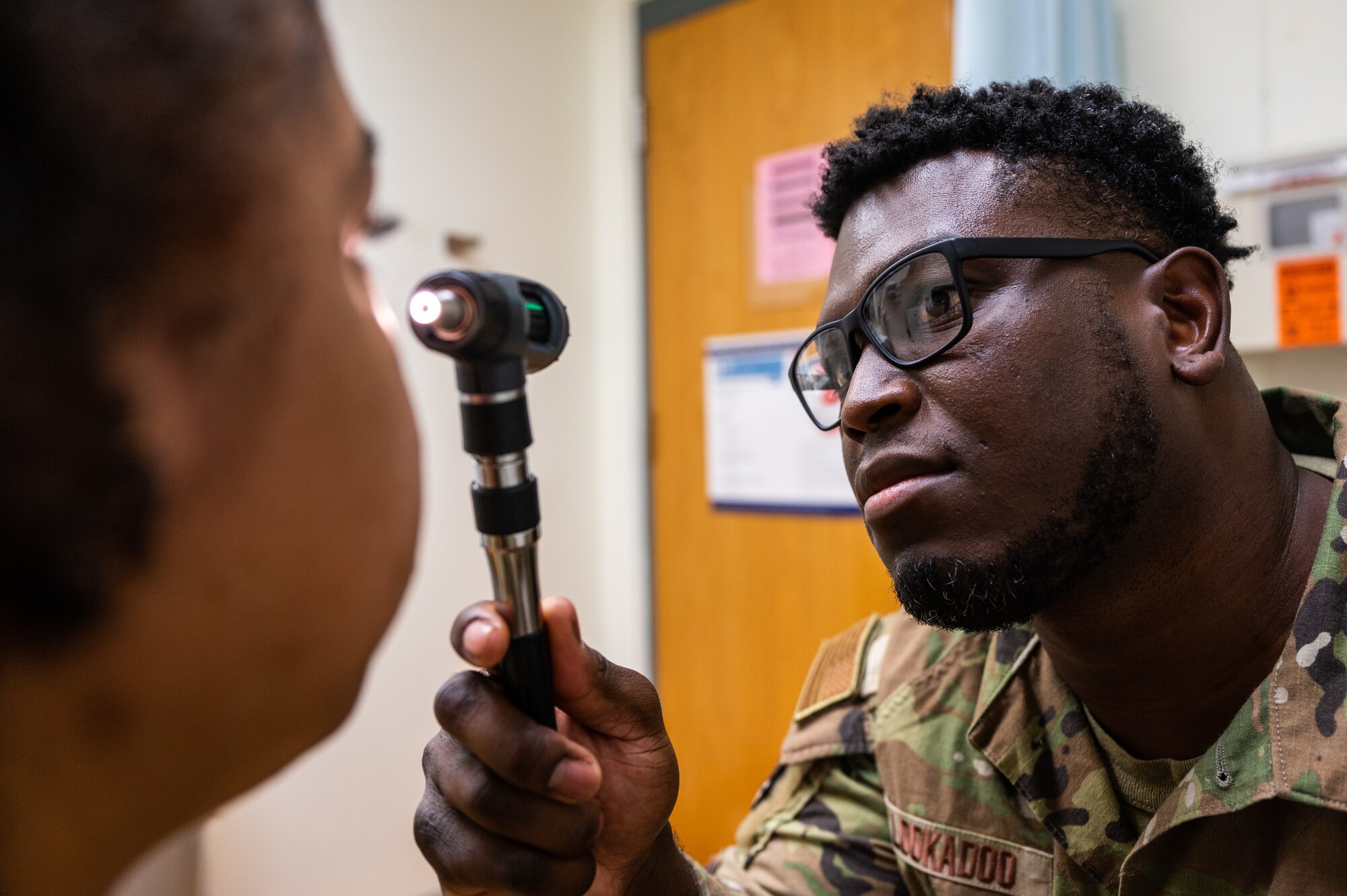 Staff Sgt. Emanuel Lookadoo examines a patient's eye during a routine check-up.