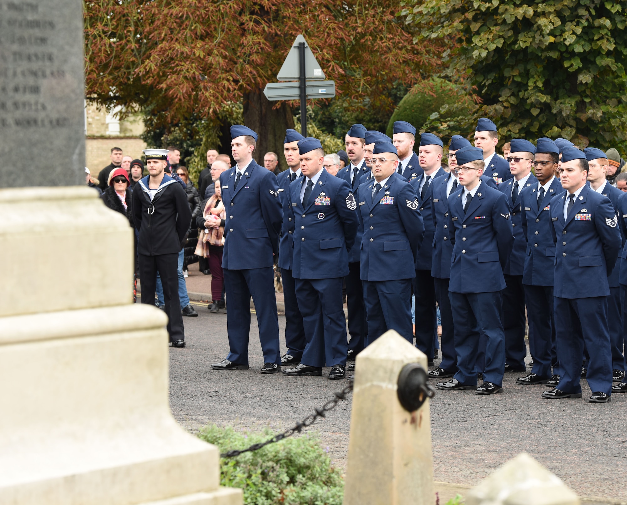 U.S. Airmen from the 100th Maintenance Group stand in formation at the war memorial during a Remembrance Sunday parade, alongside Royal British Legion members and other groups from the local community in Mildenhall, Suffolk, England, Nov. 12, 2023. Two minutes of silence were observed immediately after the playing of “The Last Post,” followed by Reveille. Team Mildenhall Airmen participated in Remembrance Sunday parades throughout the local area and East Anglia. (U.S. Air Force photo by Karen Abeyasekere)