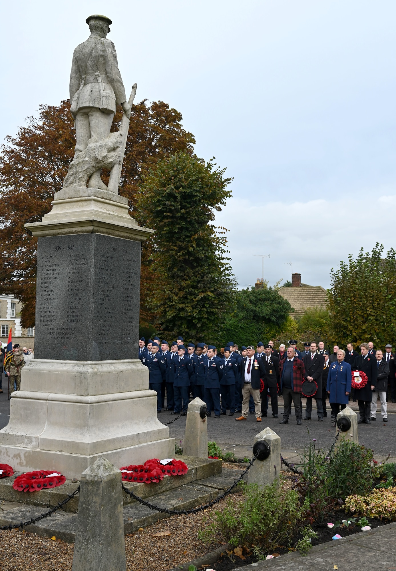 U.S. Airmen from the 100th Maintenance Group stand in formation at the war memorial during a Remembrance Sunday parade, alongside Royal British Legion members and other groups from the local community in Mildenhall, Suffolk, England, Nov. 12, 2023. Two minutes of silence were observed immediately after the playing of “The Last Post,” followed by Reveille. Team Mildenhall Airmen participated in Remembrance Sunday parades throughout the local area and East Anglia. (U.S. Air Force photo by Karen Abeyasekere)
