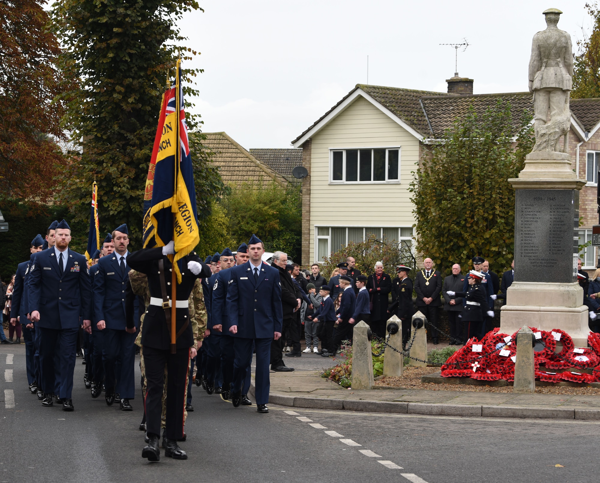 U.S. Airmen from the 100th Maintenance Group march at the end of a Remembrance Sunday parade, alongside Royal British Legion members and other groups from the local community in Mildenhall, Suffolk, England, Nov. 12, 2023. Two minutes of silence were observed immediately after the playing of “The Last Post,” followed by Reveille. Team Mildenhall Airmen participated in Remembrance Sunday parades throughout the local area and East Anglia. (U.S. Air Force photo by Karen Abeyasekere)