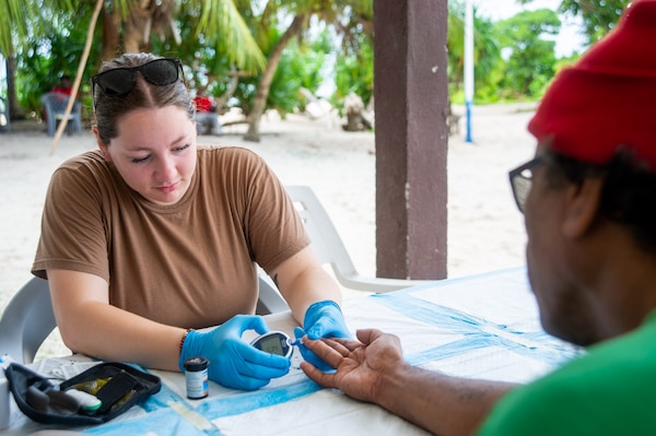 U.S. Navy Hospital Corpsman 3rd Class Lindsay McCarthney, from Griffin, Georgia, checks the blood sugar level of a Marshallese patient during a tuberculosis eradication clinic in Aur Atoll, Republic of the Marshall Islands, as part of Pacific Partnership 2024-1 Nov. 10, 2023. Now in its 19th iteration, Pacific Partnership is the largest annual multinational humanitarian assistance and disaster relief preparedness mission conducted in the Indo-Pacific. (U.S. Navy photo by Mass Communication Specialist 2nd Class Jacob Woitzel)