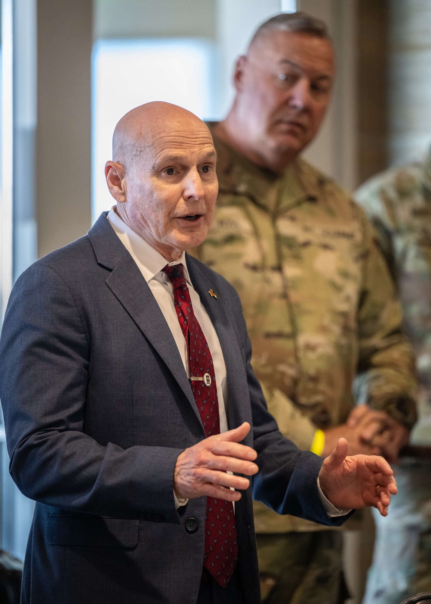 Richard Brunais, program manager for Survivor Outreach Services at the National Guard Bureau, speaks to distinguished visitors at Churchill Downs Racetrack in Louisville, Ky., Nov. 5, 2023, as U.S. Army Brig. Gen. Warner A. Ross II, adjutant general of the Tennessee National Guard, looks on. The event was part of Survivor’s Day at the Races, an annual day of activities held to honor family members who have lost loved ones in military service to the United States. Hosted with assistance from the Kentucky National Guard, the event drew more than 700 family members from 18 states. (U.S. Air National Guard photo by Dale Greer)